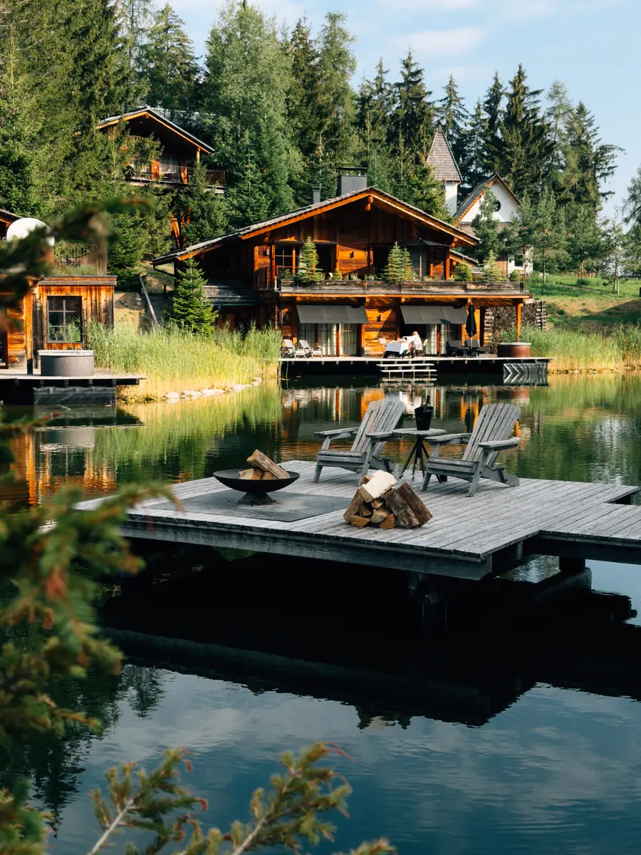 Wooden lakeside chalet with a jetty at dusk